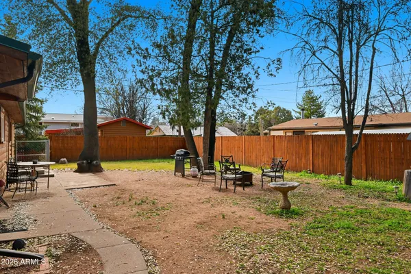 a backyard of a house with table and chairs