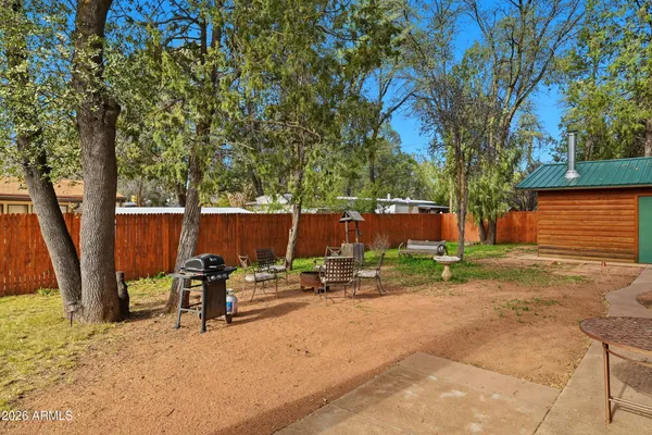 a backyard of a house with table and chairs