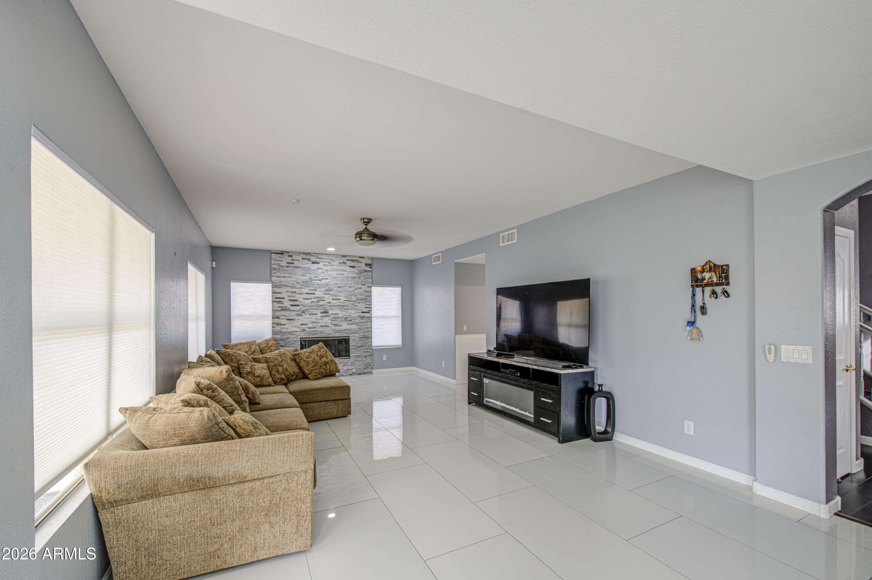 12403 West Monte Vista Road Avondale, AZ 85392 - Photo 15 of 63 a living room with furniture and a flat screen tv