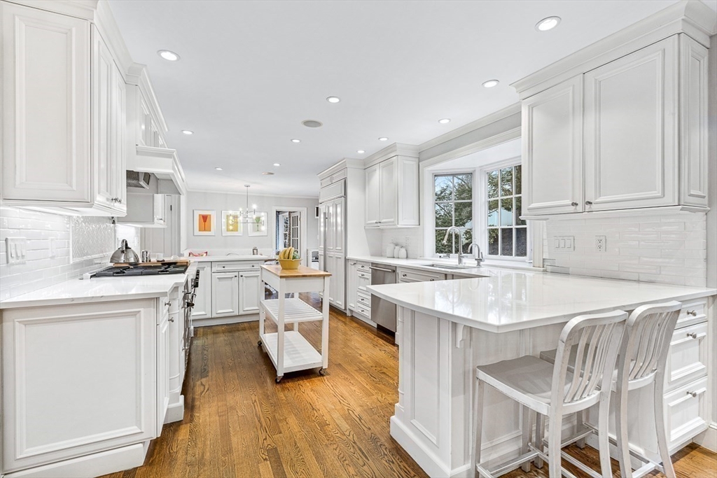14 Rockridge Road Wellesley, MA 02481 - Photo 12 of 42 a kitchen with stainless steel appliances granite countertop a sink a stove a refrigerator and white cabinets with wooden floor