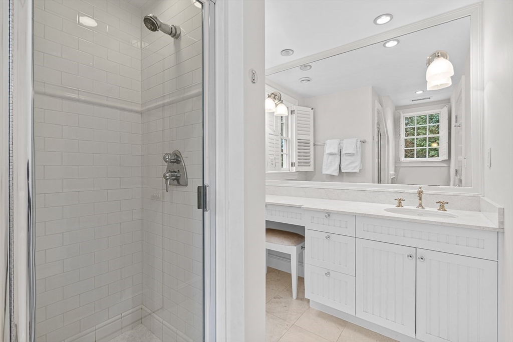 14 Rockridge Road Wellesley, MA 02481 - Photo 37 of 42 a bathroom with a double vanity sink a mirror and a shower