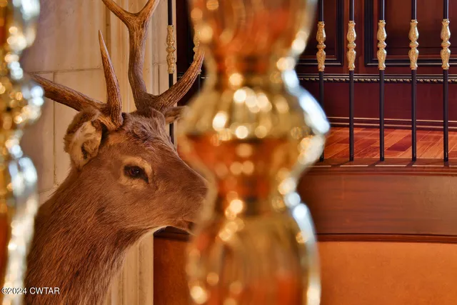 a living room with couches a flat screen tv and kitchen view