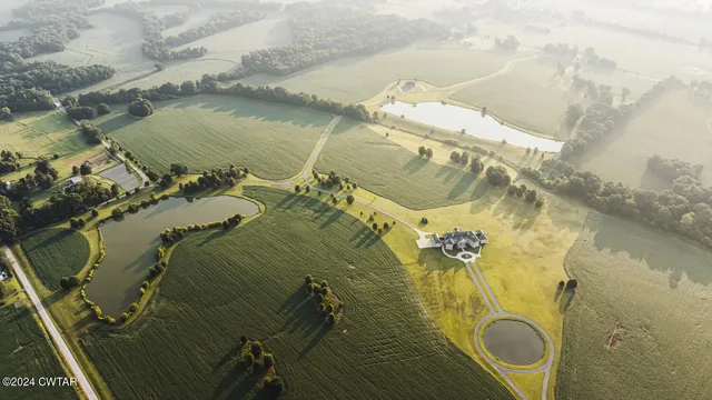 an aerial view of a house with a yard