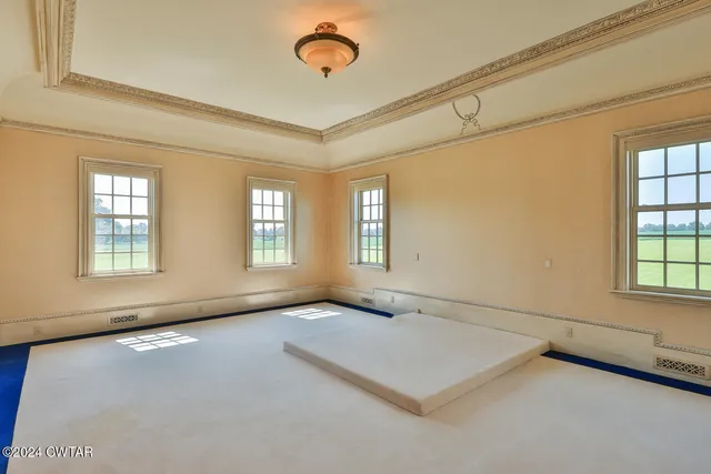 a view of an empty room with empty shelves