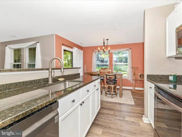 a kitchen with a stove a sink and a microwave