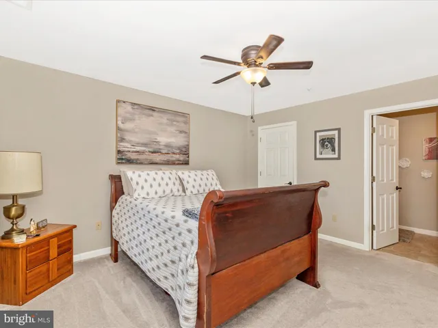 a bathroom with a granite countertop sink a toilet and a mirror