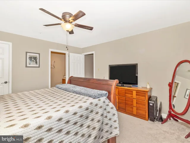 a view of a bedroom with a bed and a furniture
