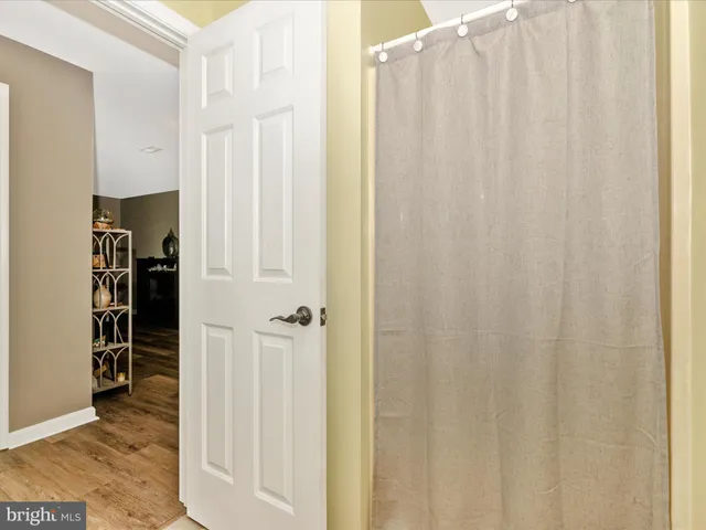 a front view of a building with a garden and plants