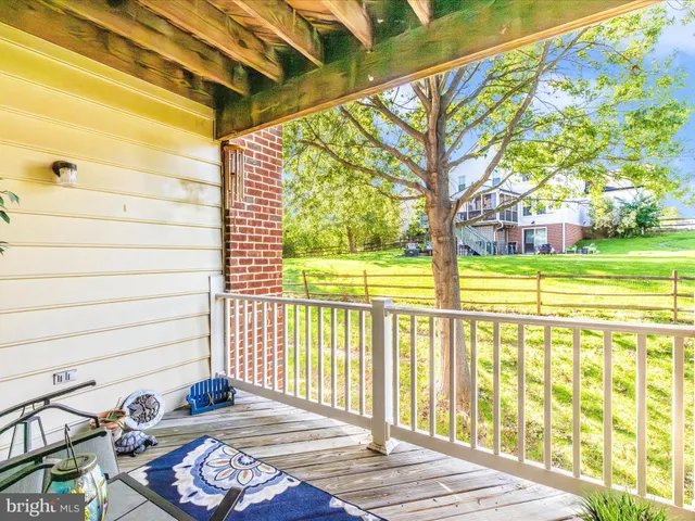 a view of a brick house with swimming pool and sitting area