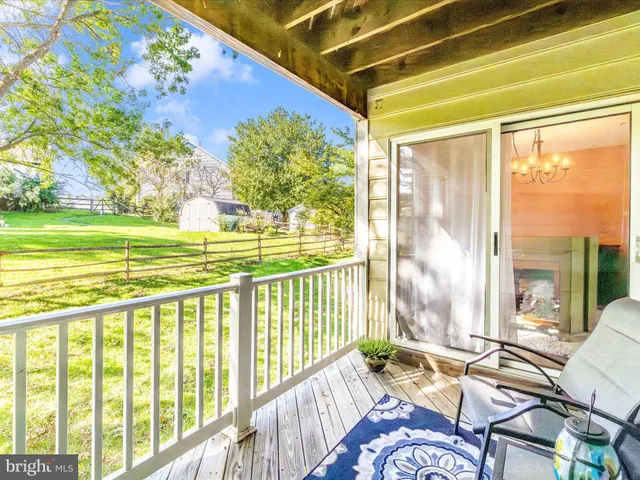 a view of a swimming pool with lawn chairs and a big yard