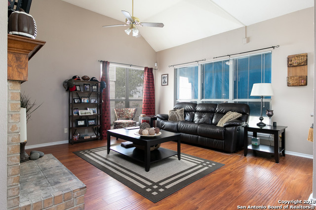5858 Spring Square San Antonio, TX 78247 - Photo 12 of 21 a living room with furniture a table and wooden floor