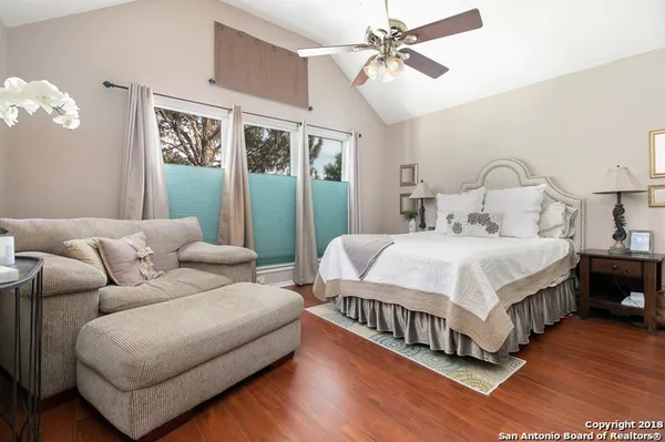 a bedroom with a bed couch and window