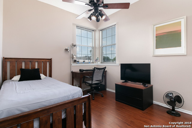 5858 Spring Square San Antonio, TX 78247 - Photo 16 of 21 a bedroom with a bed and a flat screen tv