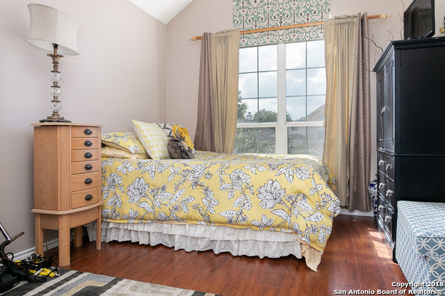 5858 Spring Square San Antonio, TX 78247 - Photo 18 of 21 a bedroom with a bed and wooden floor