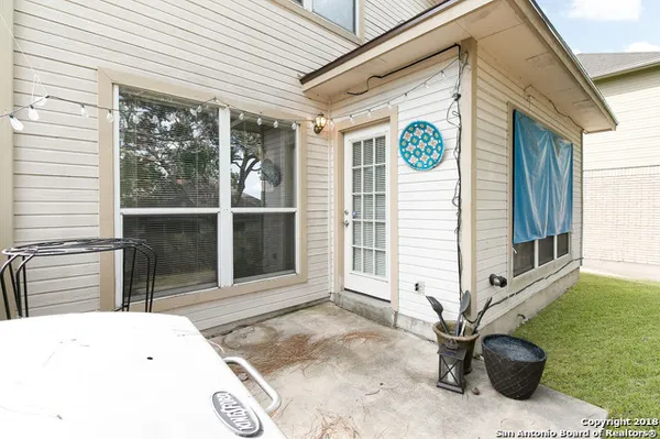 a backyard of a house with table and chairs
