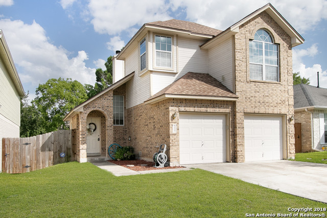 5858 Spring Square San Antonio, TX 78247 - Photo 3 of 21 a front view of a house with a yard and garage