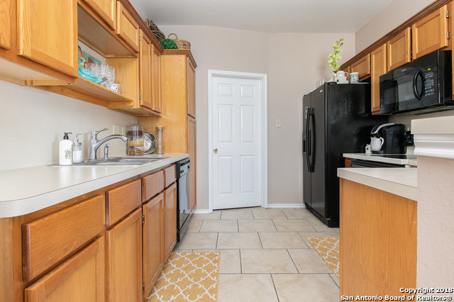 5858 Spring Square San Antonio, TX 78247 - Photo 8 of 21 a kitchen with stainless steel appliances a sink a refrigerator and cabinets