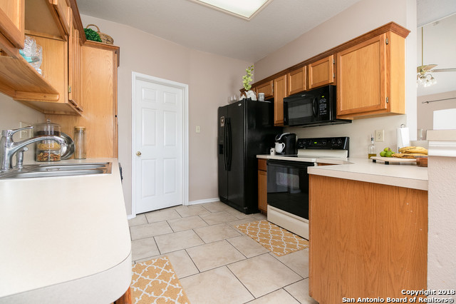 5858 Spring Square San Antonio, TX 78247 - Photo 9 of 21 a kitchen with stainless steel appliances granite countertop a refrigerator stove top oven a sink and dishwasher