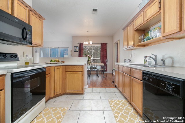 5858 Spring Square San Antonio, TX 78247 - Photo 10 of 21 a kitchen with stainless steel appliances a stove a sink and a microwave