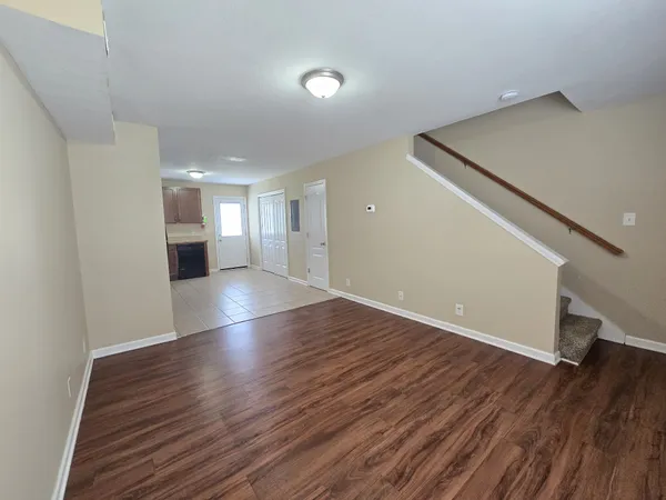 a view of a hallway with wooden floor