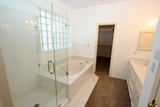 a bathroom with a bathtub and a shower