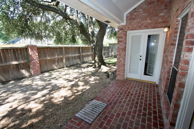 a backyard of a house with table and chairs