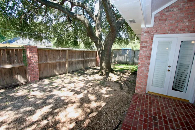 a backyard of a house with barbeque oven