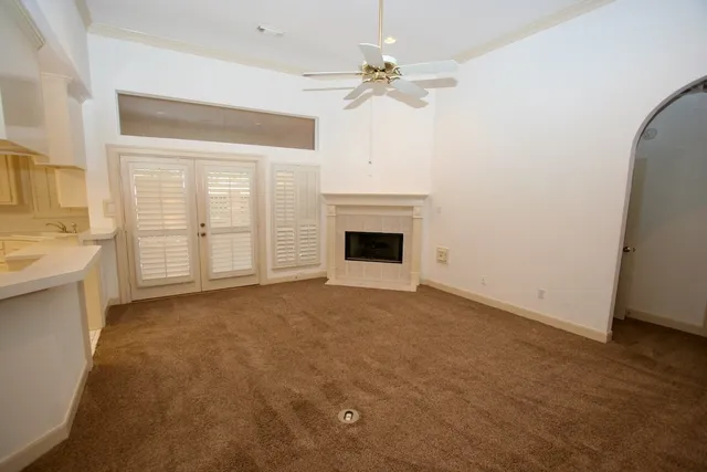 a view of empty room with a fireplace and fan