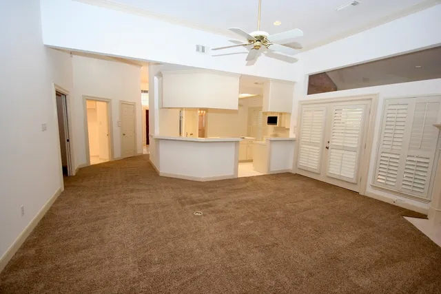 a view of a kitchen with a sink and a window