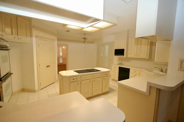 a kitchen with a sink a stove and refrigerator