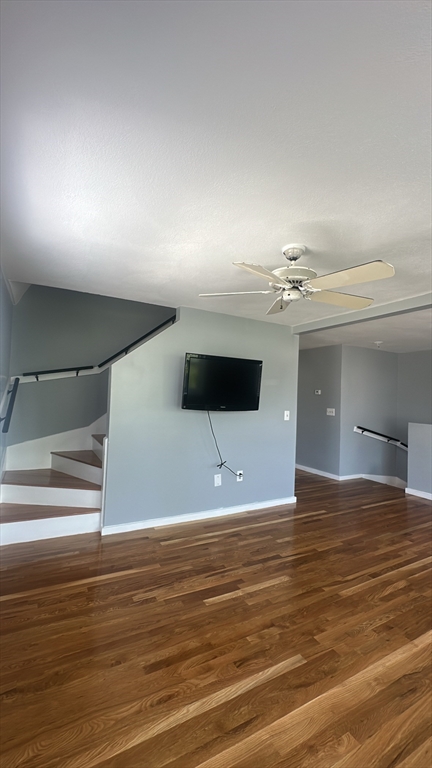 155 Cottage Street, Unit 2 Everett, MA 02149 - Photo 4 of 8 a view of a room with a ceiling fan and wooden floor