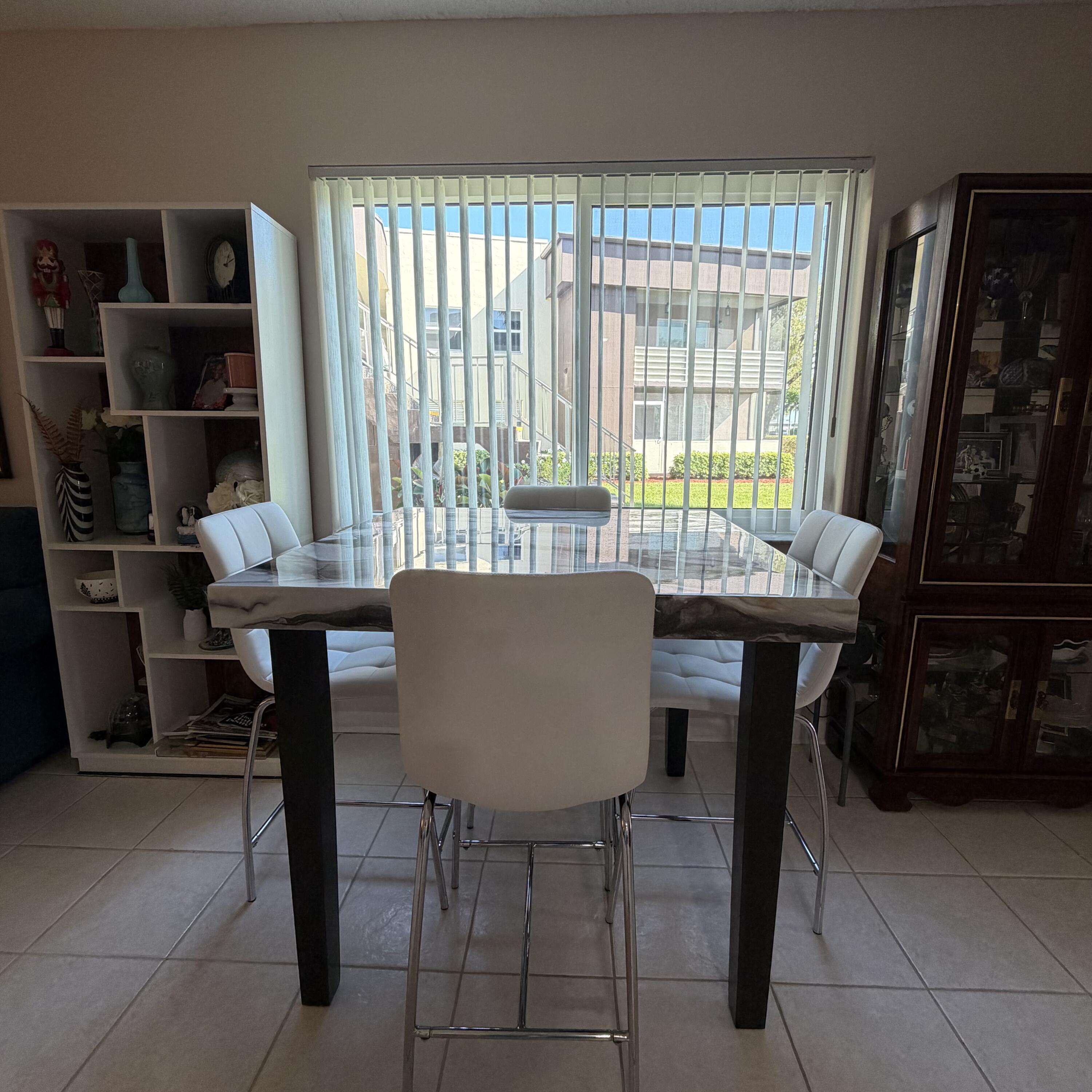 728 Normandy Lane, Unit P Delray Beach, FL 33484 - Photo 2 of 12 a view of a dining room with furniture and a window