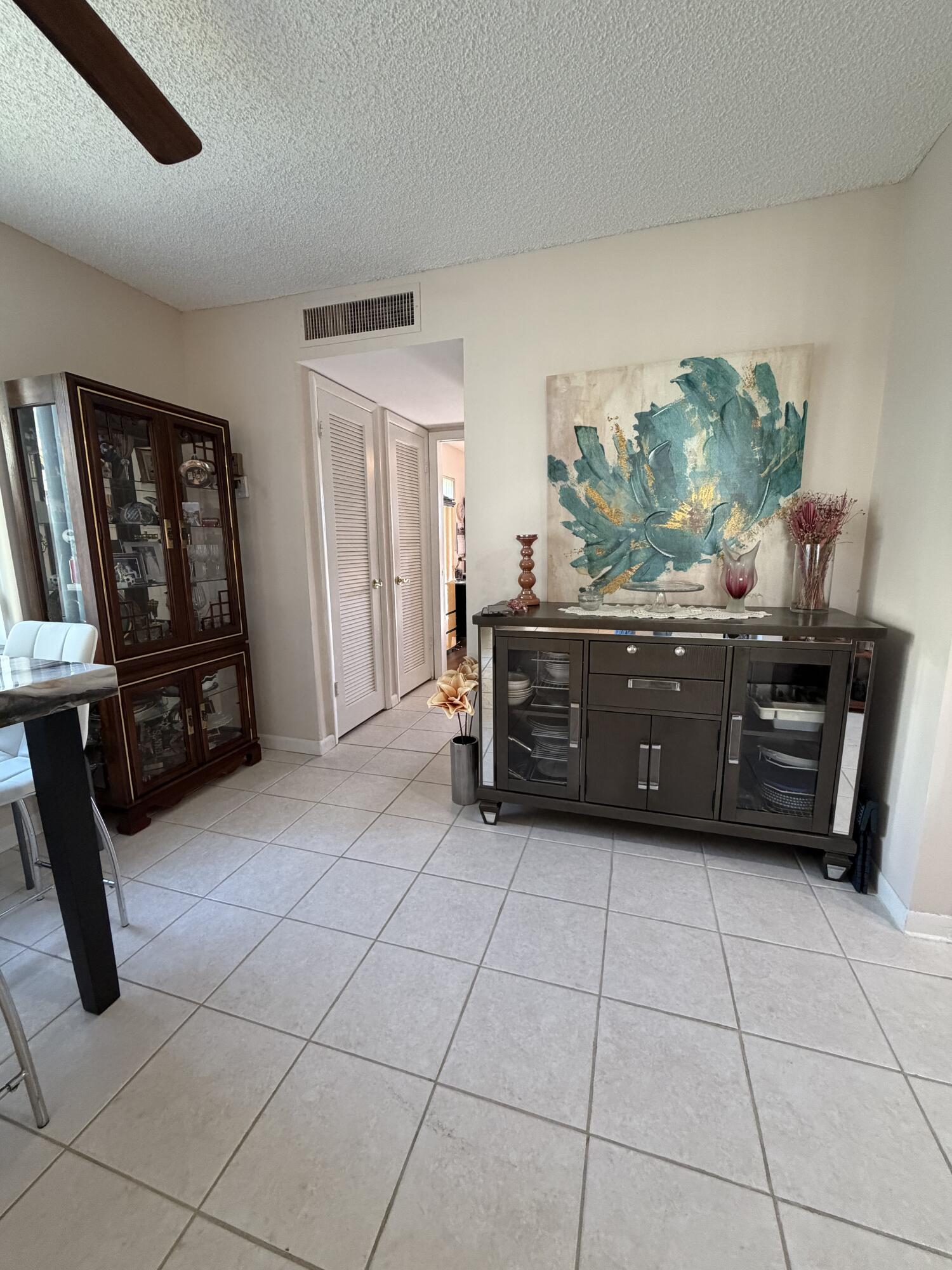 728 Normandy Lane, Unit P Delray Beach, FL 33484 - Photo 3 of 12 a view of kitchen with furniture and staircase