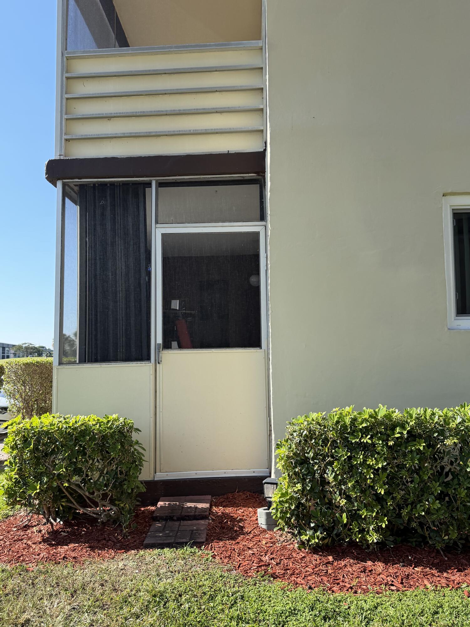 728 Normandy Lane, Unit P Delray Beach, FL 33484 - Photo 10 of 12 a view of backyard with potted plants