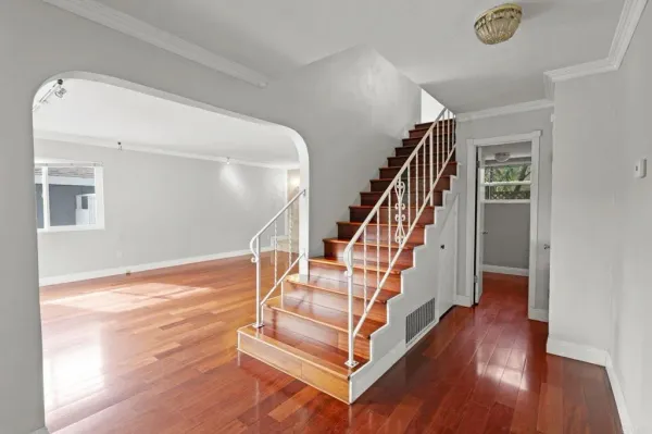 a view of entryway and hall with wooden floor