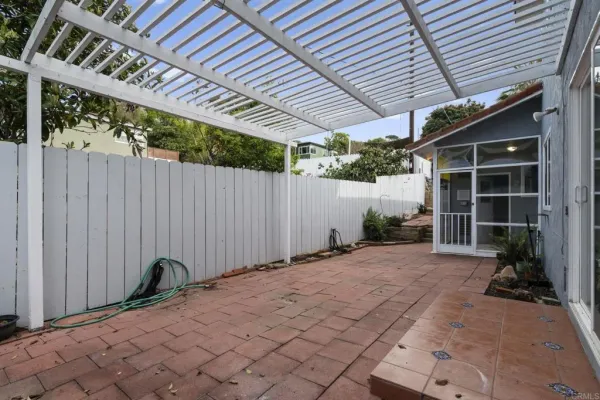 a backyard of a house with table and chairs