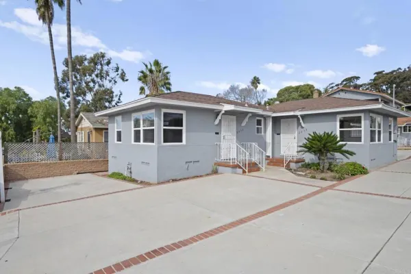 a front view of a house with a yard and a garage