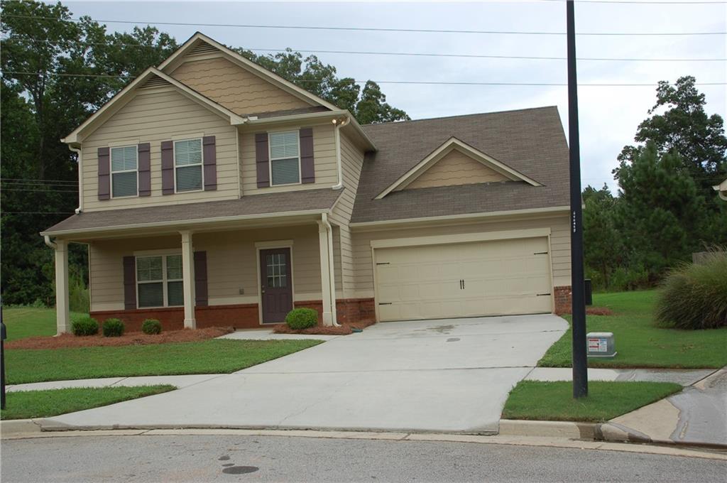 3245 Ivey Ridge Road Northeast Buford, GA 30519 - Photo 1 of 1 a view of a brick house with a yard plants and a large tree