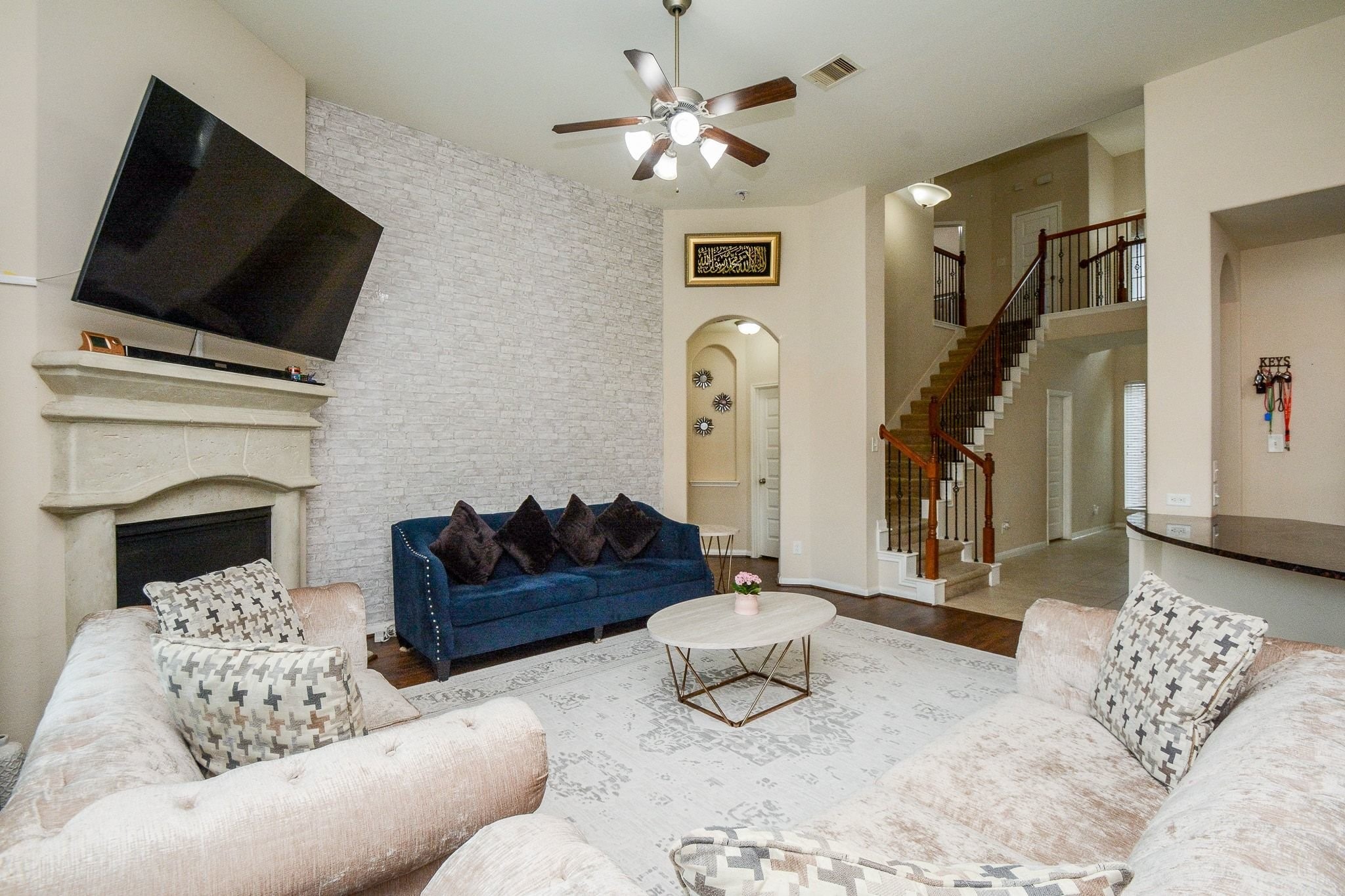 7046 Sliding Rock Circle Spring, TX 77379 - Photo 8 of 41 Discover a spacious, inviting living room featuring elegant high ceilings, a cozy fireplace, and abundant natural light. Perfect for entertaining or relaxing.