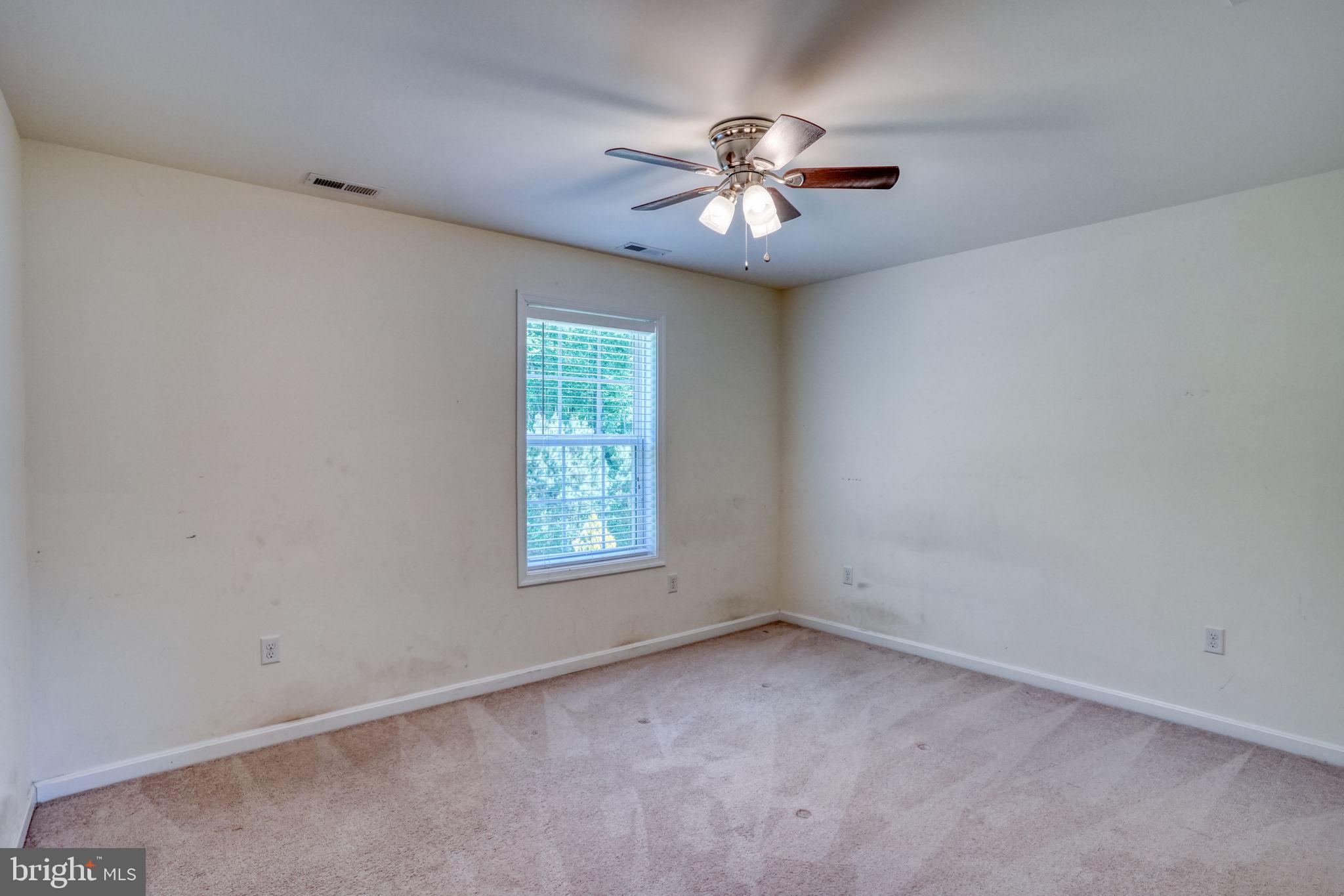 107 Hunters Run Magnolia, DE 19962 - Photo 26 of 41 an empty room with a chandelier fan and windows