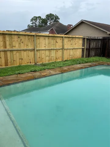 a view of an house with backyard space and city view