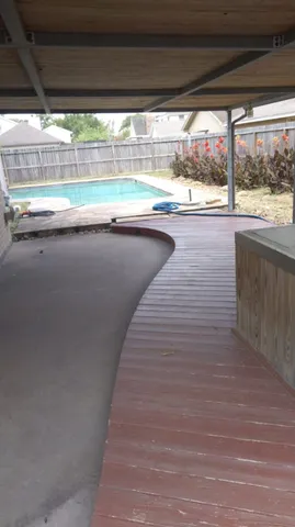 a view of swimming pool with wooden floor