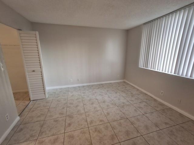741 Lyons Road, Unit 17106 Coconut Creek, FL 33063 - Photo 20 of 28 a view of an empty room and window