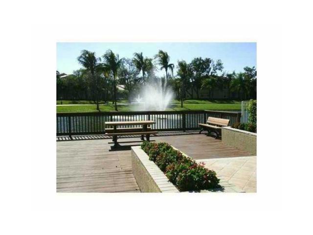 741 Lyons Road, Unit 17106 Coconut Creek, FL 33063 - Photo 26 of 28 a view of outdoor space with garden