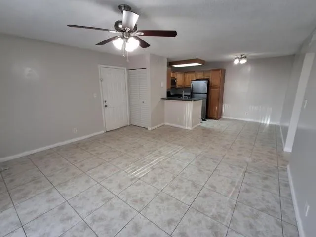 a view of a livingroom with a sink furniture and chandelier fan
