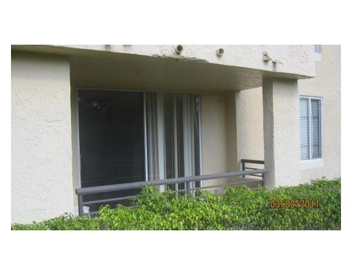 741 Lyons Road, Unit 17106 Coconut Creek, FL 33063 - Photo 8 of 28 a couple of white house with a small yard and plants