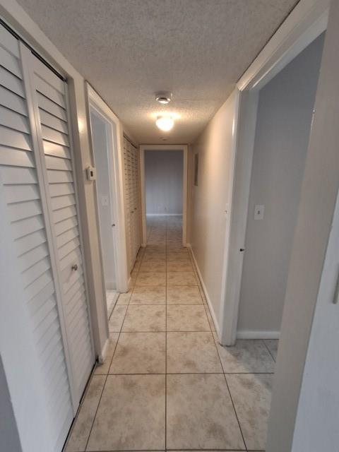 741 Lyons Road, Unit 17106 Coconut Creek, FL 33063 - Photo 10 of 28 a view of hallway with a bathtub and closet