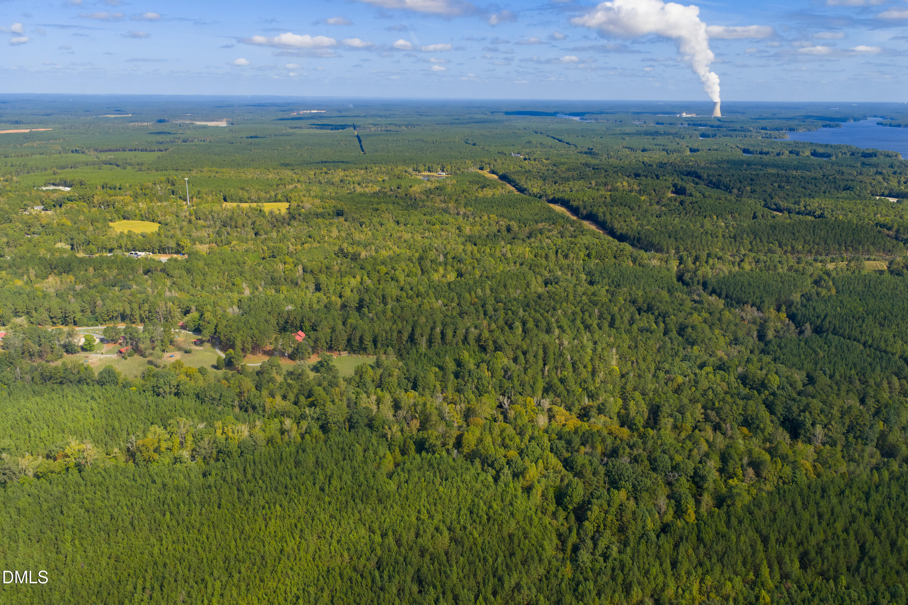 262 Ellis Road Moncure, NC 27559 - Photo 20 of 30 a view of a lake with a building in the background