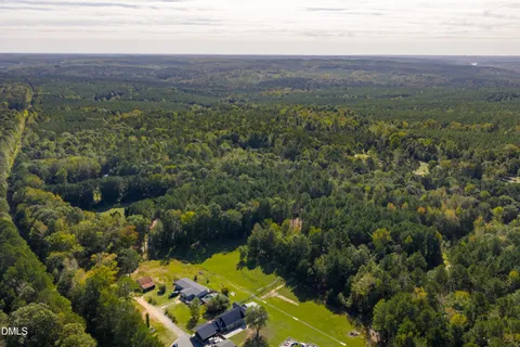 an aerial view of a houses with a yard