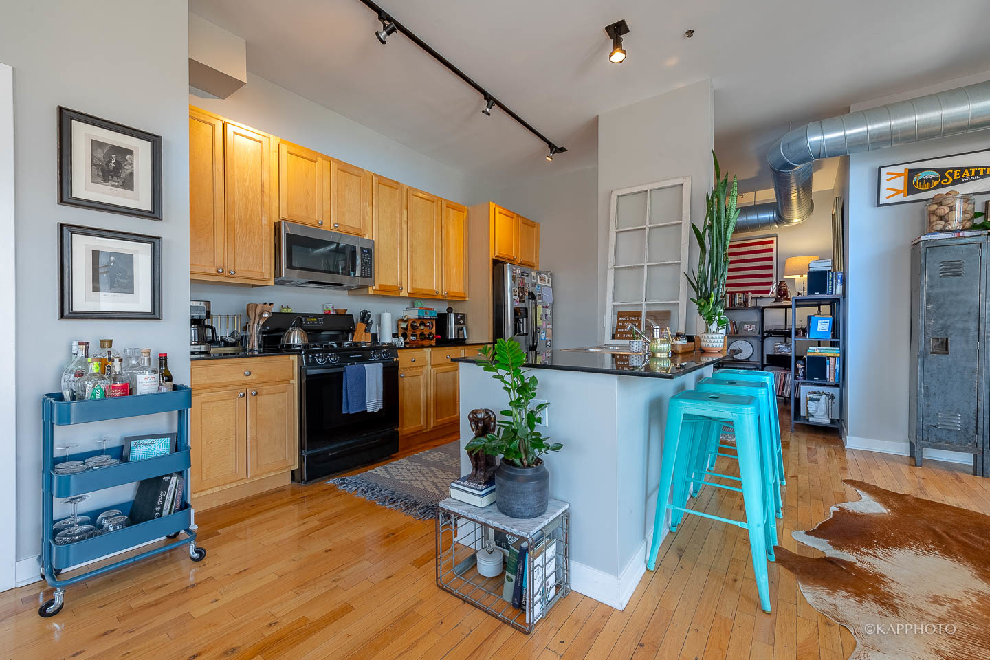 910 West Madison Street, Unit 906E Chicago, IL 60607 - Photo 13 of 26 a kitchen with refrigerator and cabinets